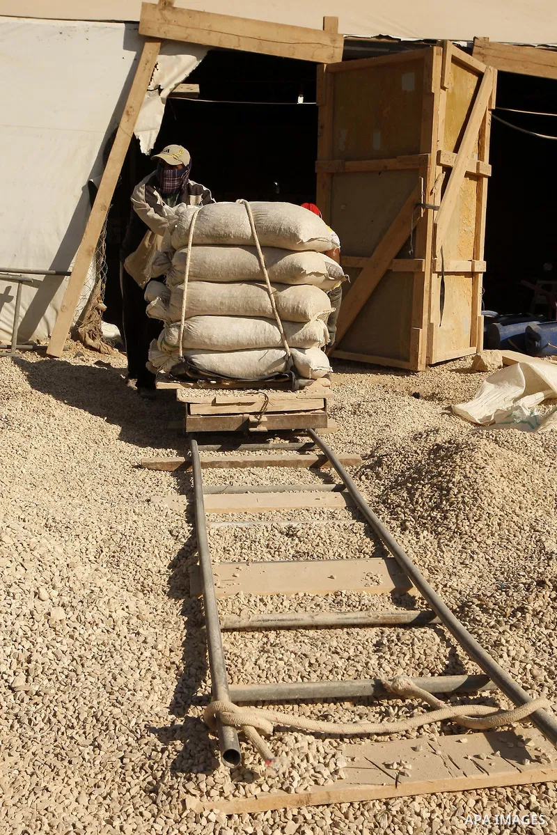 Palestinian men smuggle cement into the Gaza Strip through a tunnel under the Egypt-Gaza border in Rafah on March 14, 2011. Israel's blockade of the Gaza Strip was imposed after the militant Hamas group violently seized...