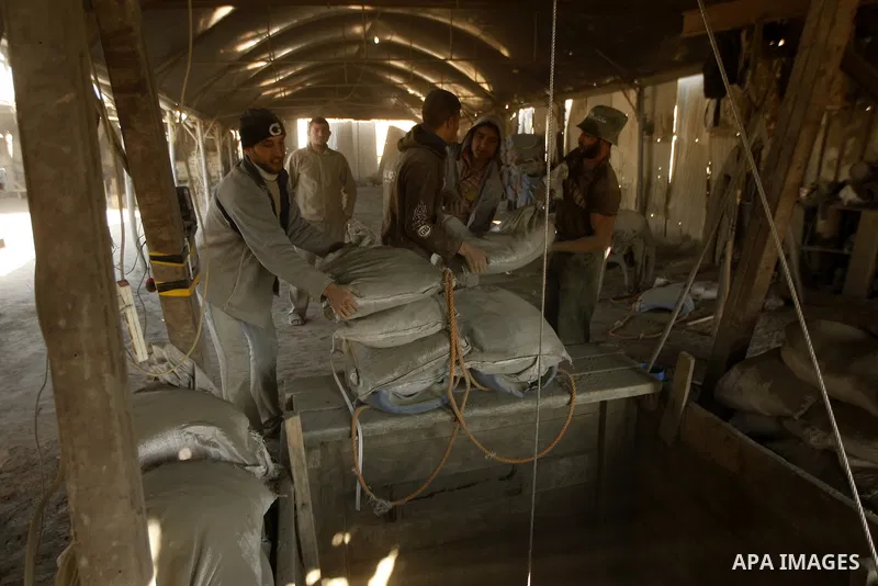 Palestinian men smuggle cement into the Gaza Strip through a tunnel under the Egypt-Gaza border in Rafah on March 14, 2011. Israel's blockade of the Gaza Strip was imposed after the militant Hamas group violently seized...