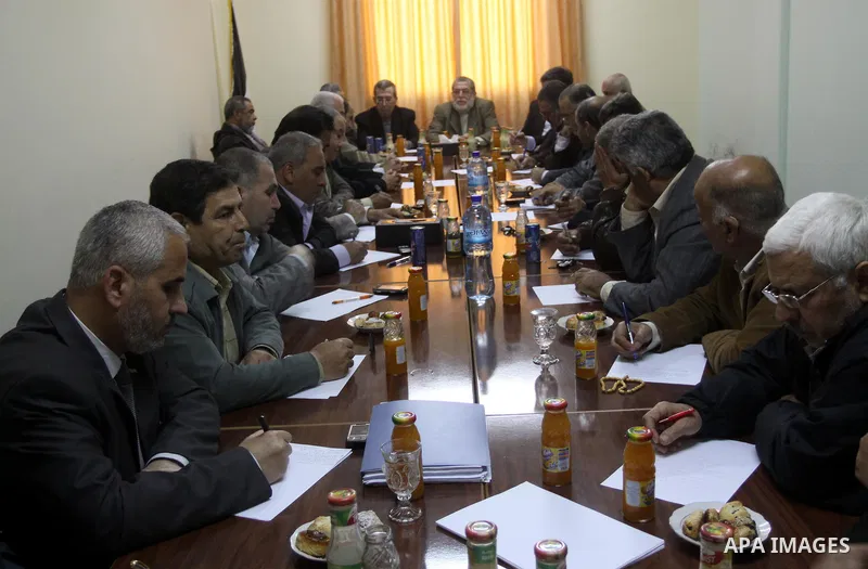 Palestinian factions leaders attend a meeting to discuss the protests calling for a reconciliation between the rival Palestinian leading factions Hamas in Gaza and Fatah in the West Bank, in Gaza City, Monday, March 14,...