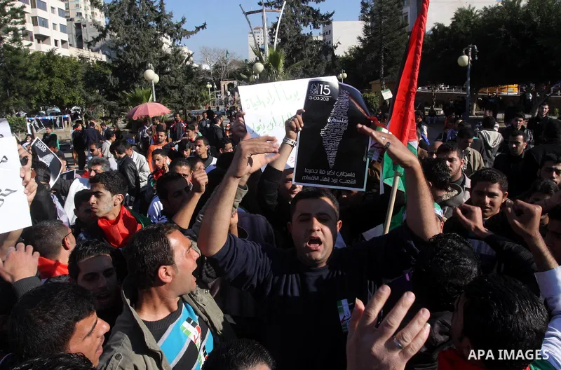 Palestinians participate in a march calling for a reconciliation between the rival Palestinian leading factions Hamas in Gaza and Fatah in the West Bank, in Gaza City, Monday, March 14, 2011. Photo by Mohammed Asad