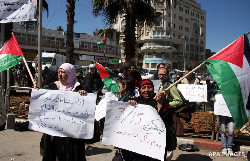 Palestinians participate in a march calling for a reconciliation between the rival Palestinian leading factions Hamas in Gaza and Fatah in the West Bank, in Ramallah, Monday, March 14, 2011. Photo by Issam Rimawi