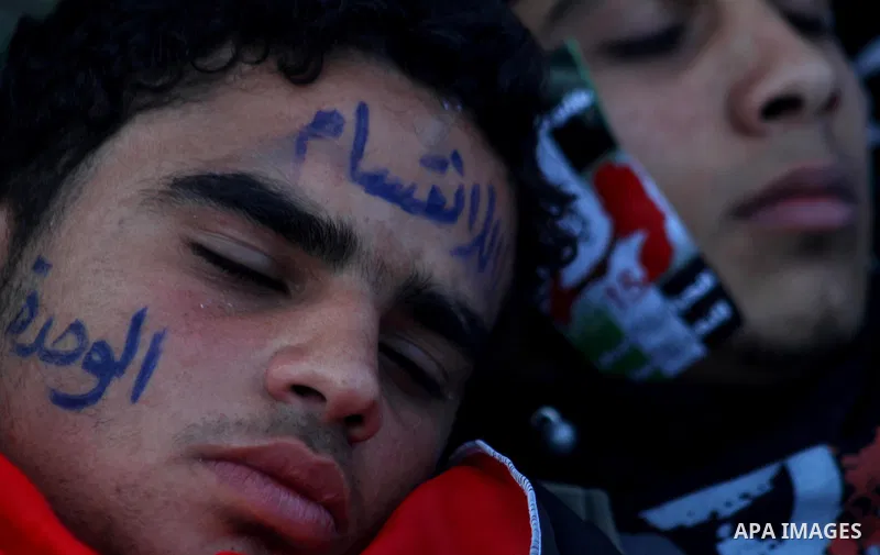Palestinians participate in a march calling for a reconciliation between the rival Palestinian leading factions Hamas in Gaza and Fatah in the West Bank, in Gaza City, Monday, March 14, 2011. Photo by Ashraf Amra