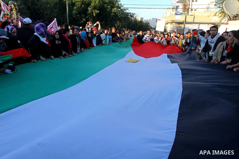 Palestinians participate in a march calling for a reconciliation between the rival Palestinian leading factions Hamas in Gaza and Fatah in the West Bank, in Gaza City, Monday, March 14, 2011. Photo by Ashraf Amra