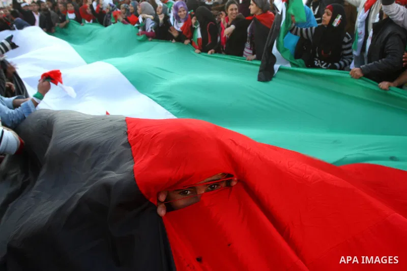 Palestinians participate in a march calling for a reconciliation between the rival Palestinian leading factions Hamas in Gaza and Fatah in the West Bank, in Gaza City, Monday, March 14, 2011. Photo by Ashraf Amra