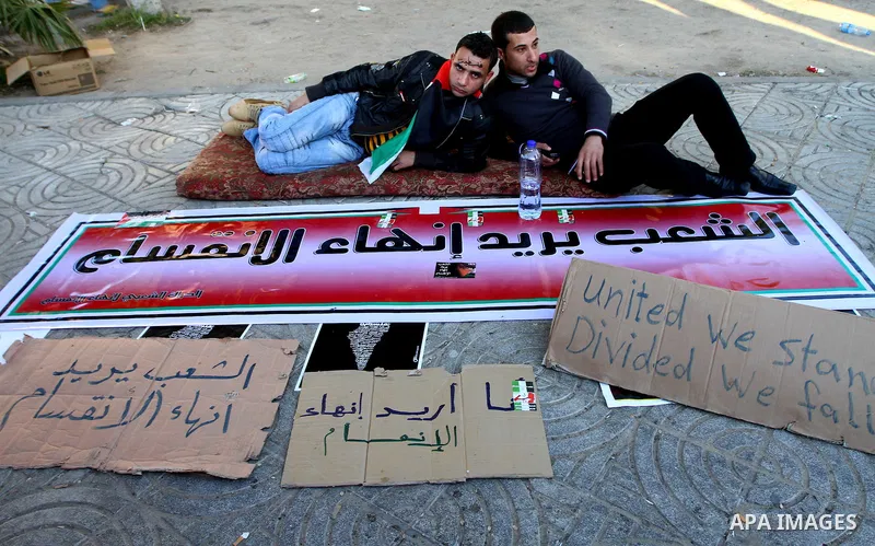 Palestinians participate in a march calling for a reconciliation between the rival Palestinian leading factions Hamas in Gaza and Fatah in the West Bank, in Gaza City, Monday, March 14, 2011. Photo by Ashraf Amra
