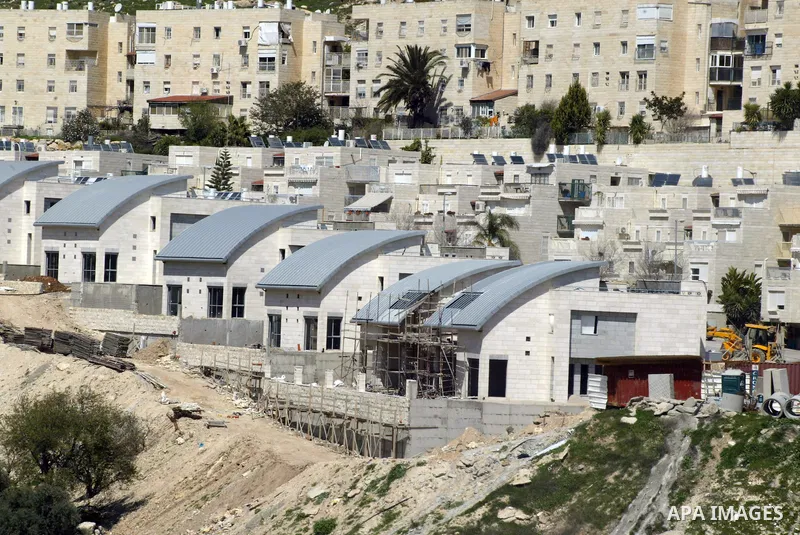 Palestinian labourers work in an Israeli settlement of Harmon Hanatziv in East jerusalem, Monday, March 14, 2011. The U.S. Embassy said Monday it was "deeply concerned" by Israel's plans to build hundreds of new homes in...