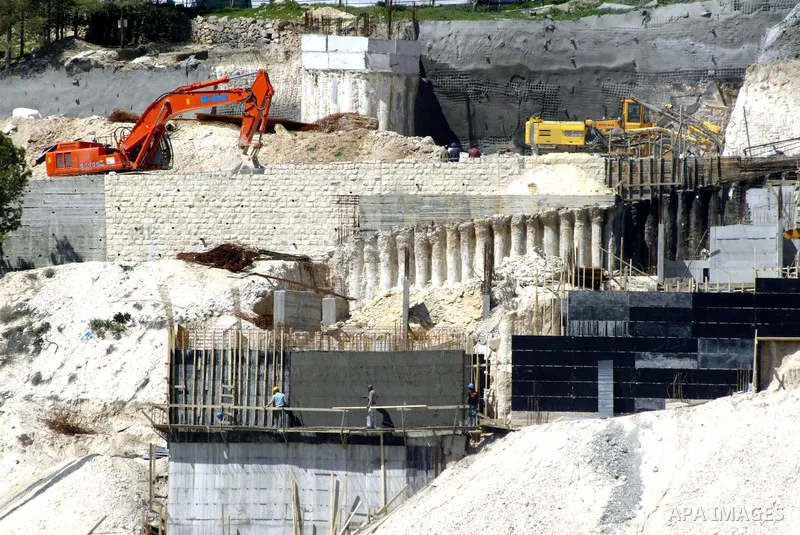 Palestinian labourers work in an Israeli settlement of Harmon Hanatziv in East jerusalem, Monday, March 14, 2011. The U.S. Embassy said Monday it was "deeply concerned" by Israel's plans to build hundreds of new homes in...