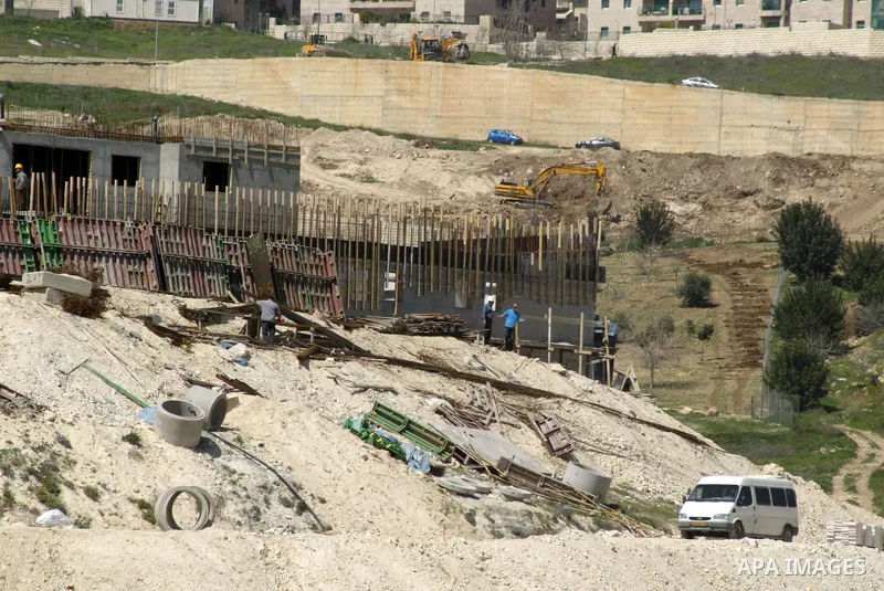 Palestinian labourers work in an Israeli settlement of Harmon Hanatziv in East jerusalem, Monday, March 14, 2011. The U.S. Embassy said Monday it was "deeply concerned" by Israel's plans to build hundreds of new homes in...