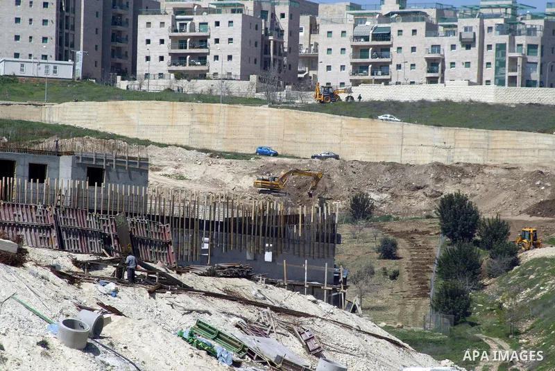 Palestinian labourers work in an Israeli settlement of Harmon Hanatziv in East jerusalem, Monday, March 14, 2011. The U.S. Embassy said Monday it was "deeply concerned" by Israel's plans to build hundreds of new homes in...