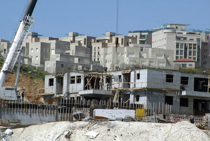 Palestinian labourers work in an Israeli settlement of Harmon Hanatziv in East jerusalem, Monday, March 14, 2011. The U.S. Embassy said Monday it was "deeply concerned" by Israel's plans to build hundreds of new homes in...
