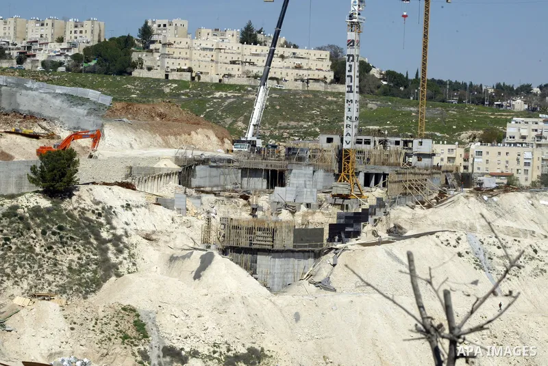 Palestinian labourers work in an Israeli settlement of Harmon Hanatziv in East jerusalem, Monday, March 14, 2011. The U.S. Embassy said Monday it was "deeply concerned" by Israel's plans to build hundreds of new homes in...
