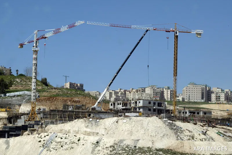 Palestinian labourers work in an Israeli settlement of Harmon Hanatziv in East jerusalem, Monday, March 14, 2011. The U.S. Embassy said Monday it was "deeply concerned" by Israel's plans to build hundreds of new homes in...