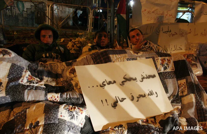 Palestinians on a hunger strike hold signs calling for national unity and an end to the political division, in reference to the bitter split between Gaza's Hamas rulers and the Fatah-dominated Palestinian Authority in th...