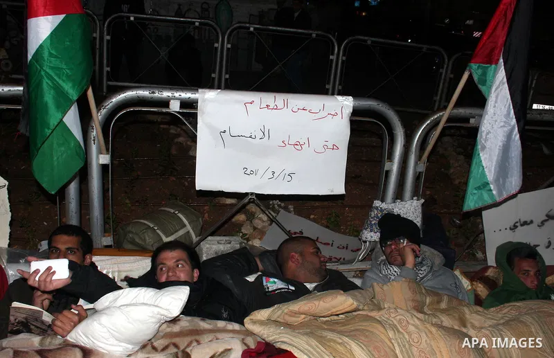 Palestinians on a hunger strike hold signs calling for national unity and an end to the political division, in reference to the bitter split between Gaza's Hamas rulers and the Fatah-dominated Palestinian Authority in th...