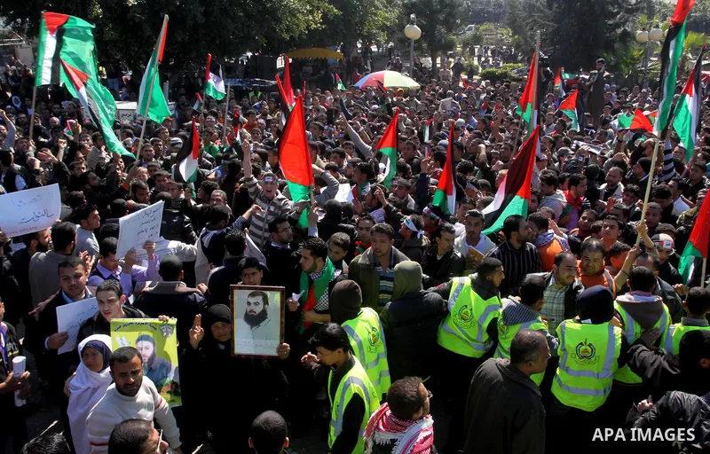 Palestinian youths take part in a rally calling for a reconciliation between the rival Palestinian leading factions Hamas in Gaza and Fatah in the West Bank, in Gaza City on March 15, 2011. Hundreds of youths demonstrate...