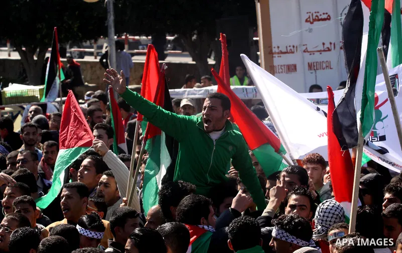 Palestinian youths take part in a rally calling for a reconciliation between the rival Palestinian leading factions Hamas in Gaza and Fatah in the West Bank, in Gaza City on March 15, 2011. Hundreds of youths demonstrate...