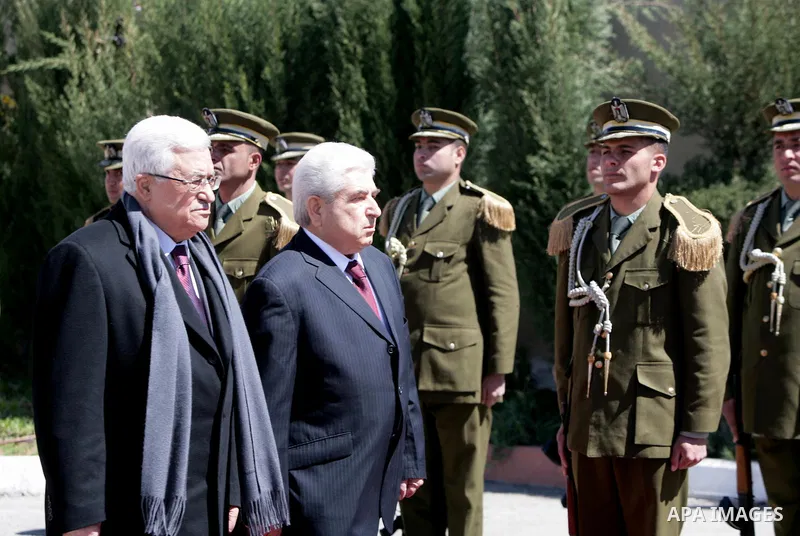 Palestinian President Mahmoud Abbas, left, and Cypriot President Dimitris Christofias review an honor guard in the West Bank city of Ramallah March 15, 2011. Christofias is on an official visit to Israel and the Palestin...