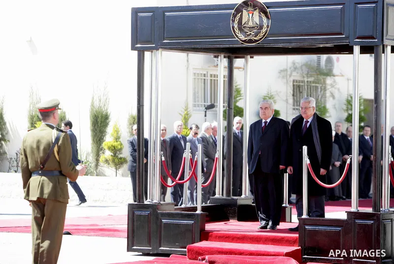 Palestinian President Mahmoud Abbas, left, and Cypriot President Dimitris Christofias review an honor guard in the West Bank city of Ramallah March 15, 2011. Christofias is on an official visit to Israel and the Palestin...