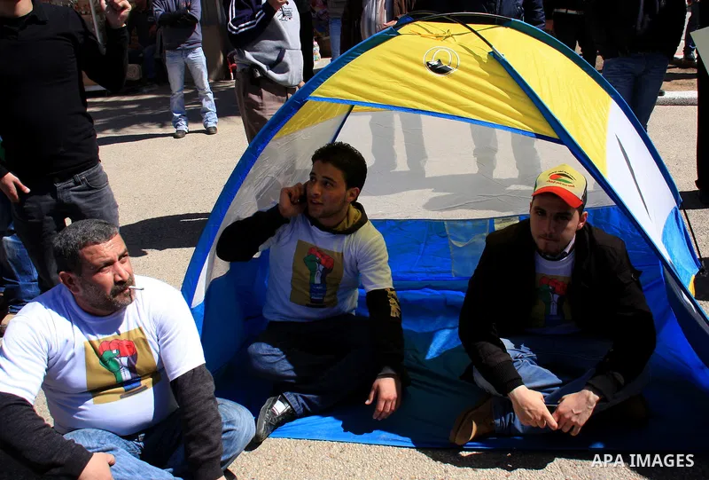 Palestinian demonstrators take part in a protest calling for Palestinian political unity between Gaza's Hamas rulers and the Fatah-dominated Palestinian Authority which rules from Ramallah, on March 15, 2011in Nablus, as...