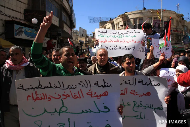 Palestinian demonstrators take part in a protest calling for Palestinian political unity between Gaza's Hamas rulers and the Fatah-dominated Palestinian Authority which rules from Ramallah, on March 15, 2011in Nablus, as...