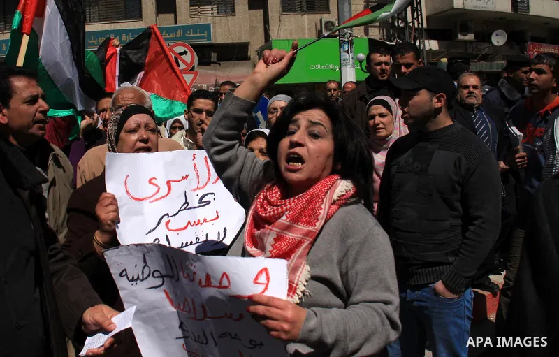 Palestinian demonstrators take part in a protest calling for Palestinian political unity between Gaza's Hamas rulers and the Fatah-dominated Palestinian Authority which rules from Ramallah, on March 15, 2011in Nablus, as...