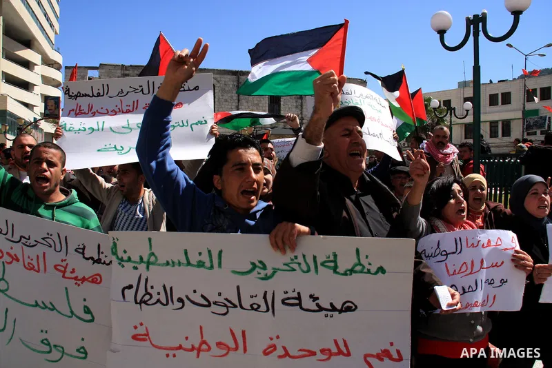 Palestinian demonstrators take part in a protest calling for Palestinian political unity between Gaza's Hamas rulers and the Fatah-dominated Palestinian Authority which rules from Ramallah, on March 15, 2011in Nablus, as...