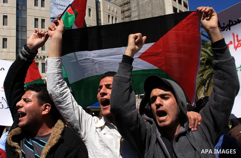 Palestinian demonstrators take part in a protest calling for Palestinian political unity between Gaza's Hamas rulers and the Fatah-dominated Palestinian Authority which rules from Ramallah, on March 15, 2011in Nablus, as...