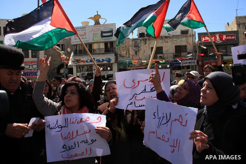 Palestinian demonstrators take part in a protest calling for Palestinian political unity between Gaza's Hamas rulers and the Fatah-dominated Palestinian Authority which rules from Ramallah, on March 15, 2011in Nablus, as...