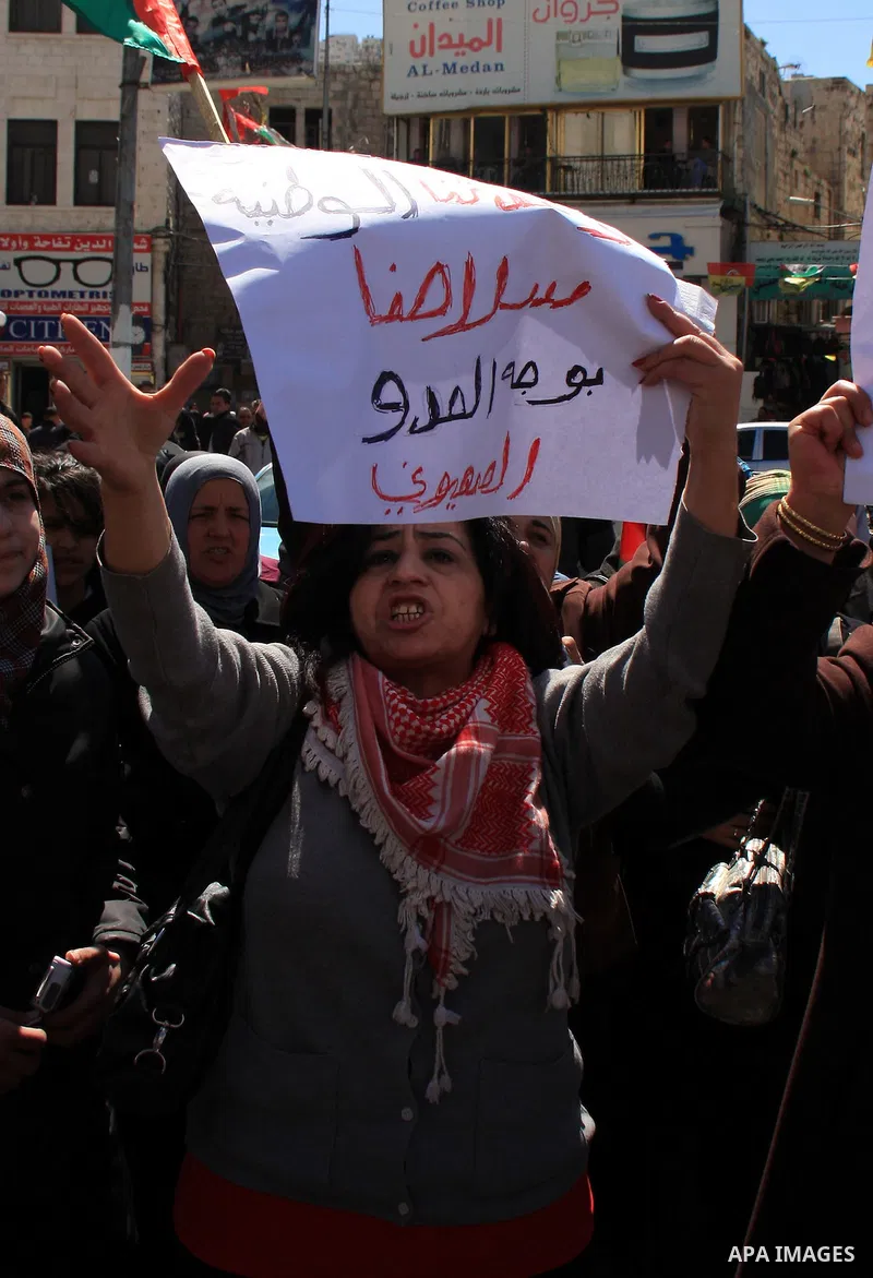 Palestinian demonstrators take part in a protest calling for Palestinian political unity between Gaza's Hamas rulers and the Fatah-dominated Palestinian Authority which rules from Ramallah, on March 15, 2011in Nablus, as...