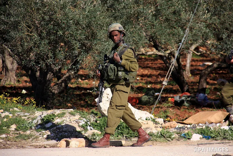 Israeli soldiers look for a Palestinian during an operation by the Israeli military in the village of Awarta near the Jewish settlement of Itamar,Tuesday, March 15, 2011. Photo by Wagdi Eshtayah