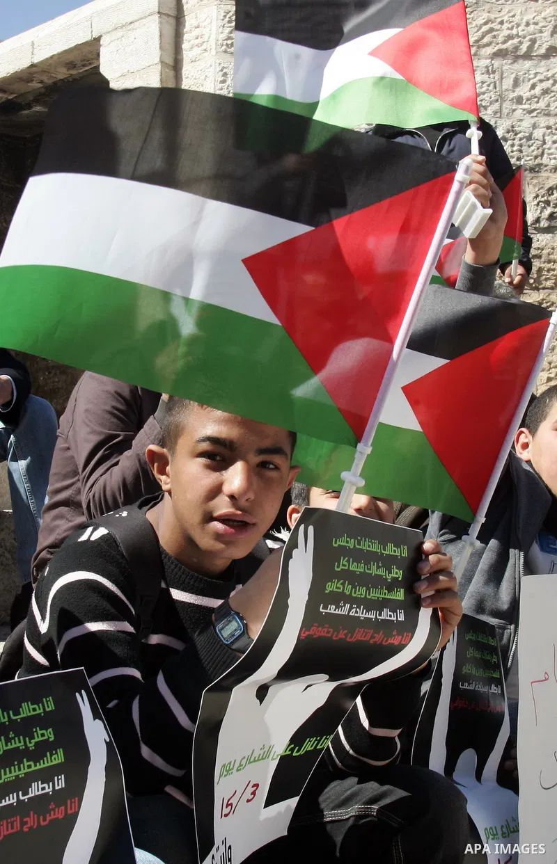 Palestinian demonstrators take part in a protest calling for Palestinian political unity between Gaza's Hamas rulers and the Fatah-dominated Palestinian Authority which rules from Ramallah, on March 15, 2011 in front of...