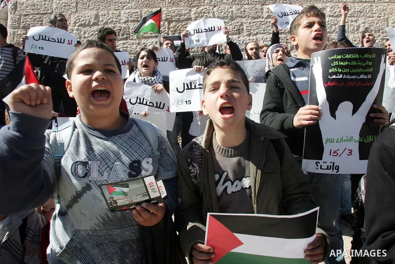 Palestinian demonstrators take part in a protest calling for Palestinian political unity between Gaza's Hamas rulers and the Fatah-dominated Palestinian Authority which rules from Ramallah, on March 15, 2011 in front of...