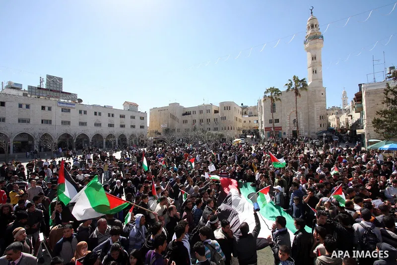 Palestinian demonstrators take part in a protest calling for Palestinian political unity between Gaza's Hamas rulers and the Fatah-dominated Palestinian Authority which rules from Ramallah, on March 15, 2011 in Bethlehem...