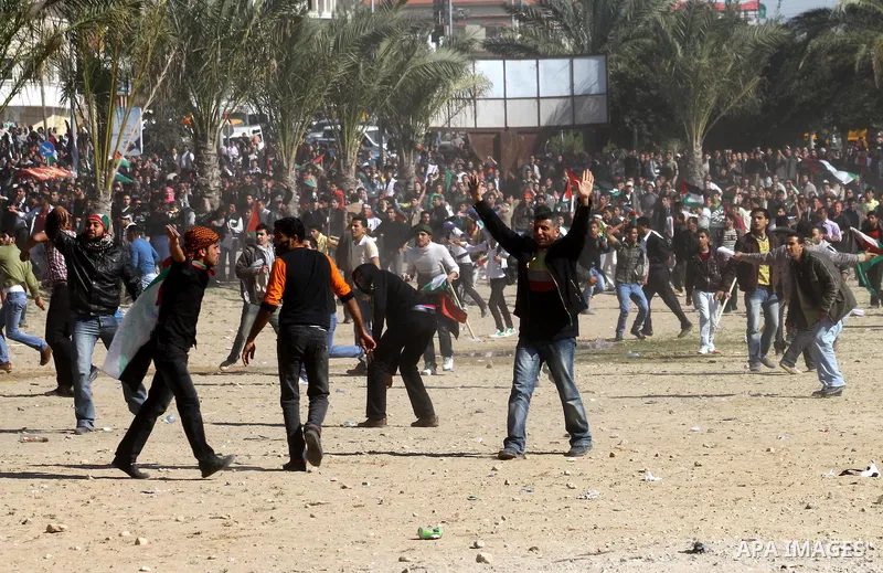 Palestinian demonstrators run during brief clashes between Hamas supporters and protestors supporting other Palestinian factions, during a rally calling for Palestinian political unity between Gaza's Hamas rulers and the...
