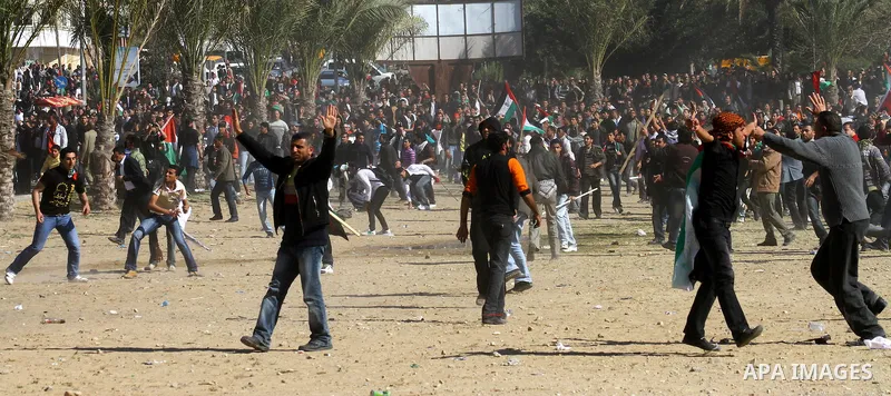 Palestinian demonstrators run during brief clashes between Hamas supporters and protestors supporting other Palestinian factions, during a rally calling for Palestinian political unity between Gaza's Hamas rulers and the...