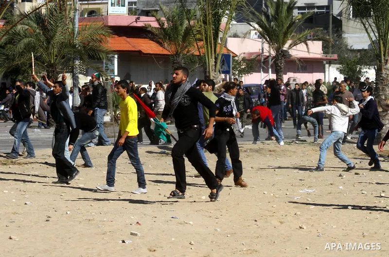 Palestinian demonstrators run during brief clashes between Hamas supporters and protestors supporting other Palestinian factions, during a rally calling for Palestinian political unity between Gaza's Hamas rulers and the...