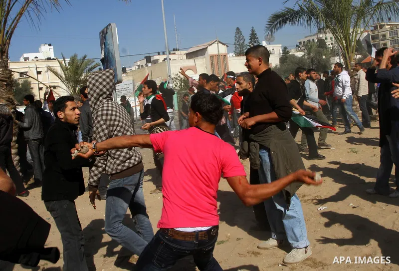 Palestinian demonstrators run during brief clashes between Hamas supporters and protestors supporting other Palestinian factions, during a rally calling for Palestinian political unity between Gaza's Hamas rulers and the...