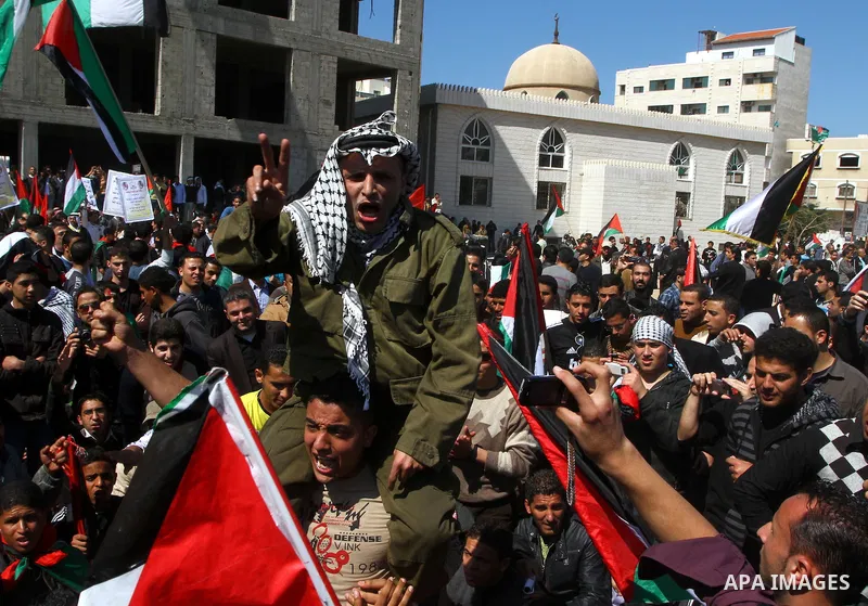 A Palestinian dressed like late Palestinian leader Yasser Arafat shouts slogans during a rally calling for Palestinian political unity between Gaza's Hamas rulers and the Fatah-dominated Palestinian Authority which rules...