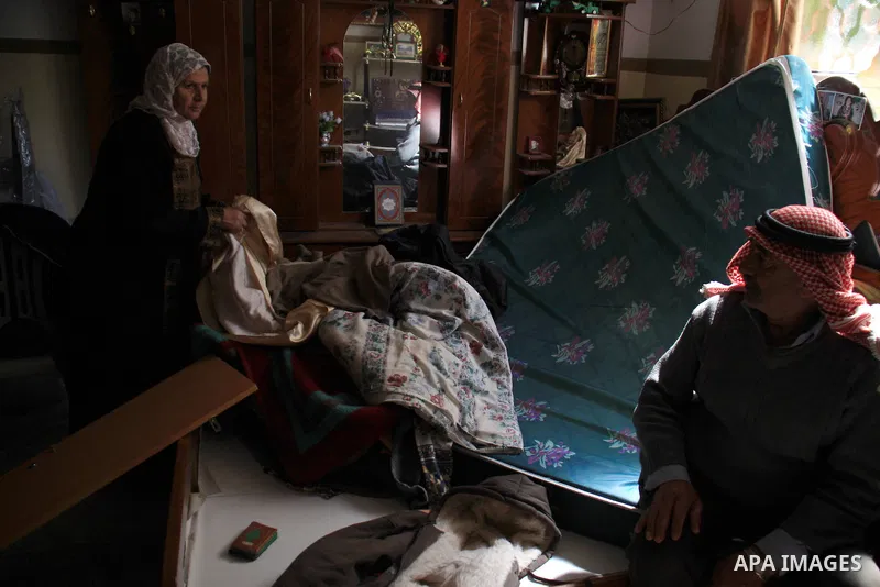 Palestinians examine their damaged room after an Israeli army raid in the West Bank village of Awarta, Wednesday, March 16, 2011. The Israeli army operated in the village in previous days following an attack in a nearby...