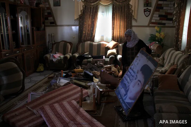 Palestinians examine their damaged room after an Israeli army raid in the West Bank village of Awarta, Wednesday, March 16, 2011. The Israeli army operated in the village in previous days following an attack in a nearby...