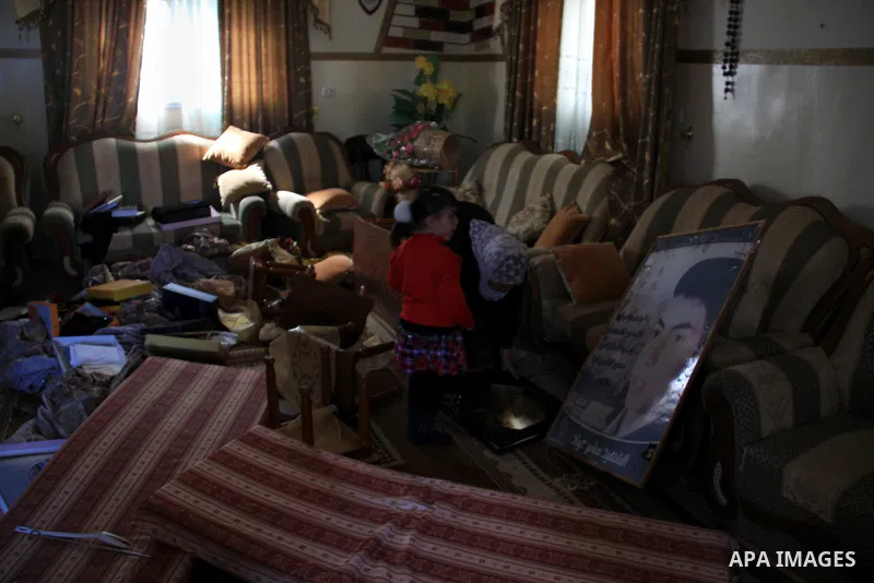 Palestinians examine their damaged room after an Israeli army raid in the West Bank village of Awarta, Wednesday, March 16, 2011. The Israeli army operated in the village in previous days following an attack in a nearby...