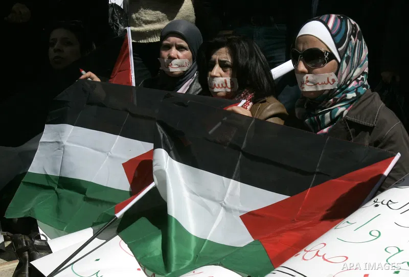 Palestinian demonastrators wave flags and chant slogans in a rally calling for a reconciliation between Fatah in west bank and hamas in Gaza strip., March 16, 2011. Photo by Wagdi Eshtayah