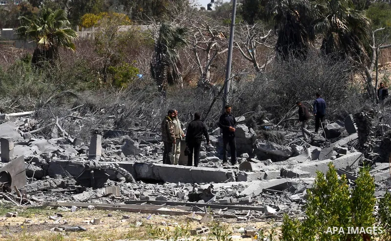 A Palestinian Hamas security officer walks through the rubble after an Israeli air strike on a Hamas training camp on the outskirts of Gaza City, Wednesday, March 16, 2011. Israeli fighter jets pummeled a Hamas facility...