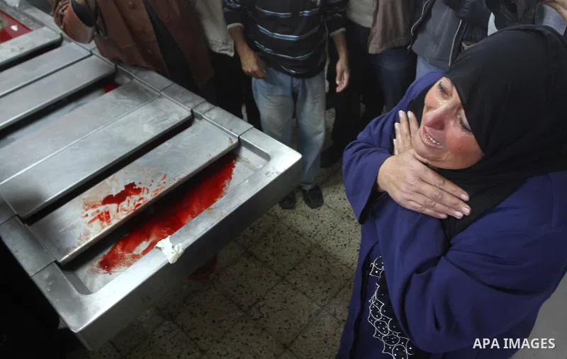 Palestinians woman grieve over the body of a Hamas militant killed in Israeli air raid at the morgue of al-Shefa hospital in Gaza City on March 16, 2011. Two Hamas militants were killed Wednesday when Israeli warplanes h...