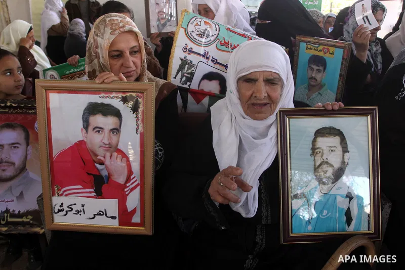 Palestinian women hold pictures of jailed relatives during a protest calling for the release of Palestinian prisoners from Israeli jails in Gaza City March 17,2011 . Photo by Mohammed Asad