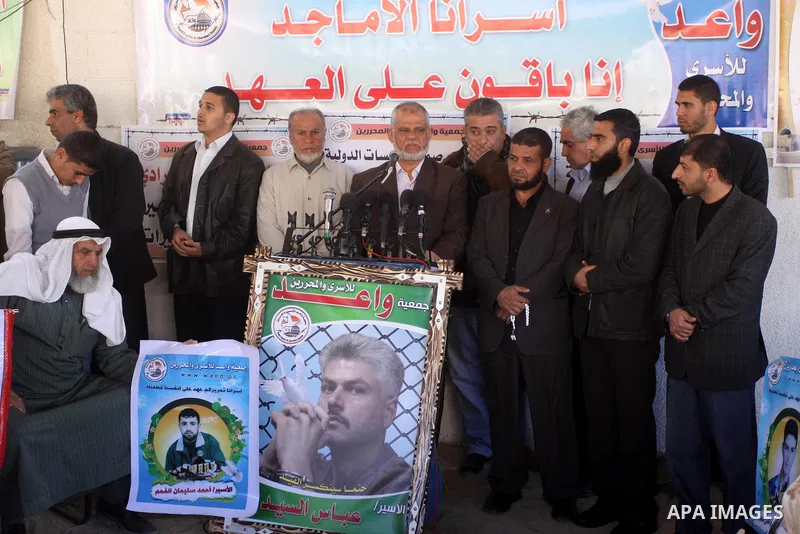 Palestinians hold pictures of jailed relatives during a protest calling for the release of Palestinian prisoners from Israeli jails in Gaza City March 17,2011 . Photo by Mohammed Asad