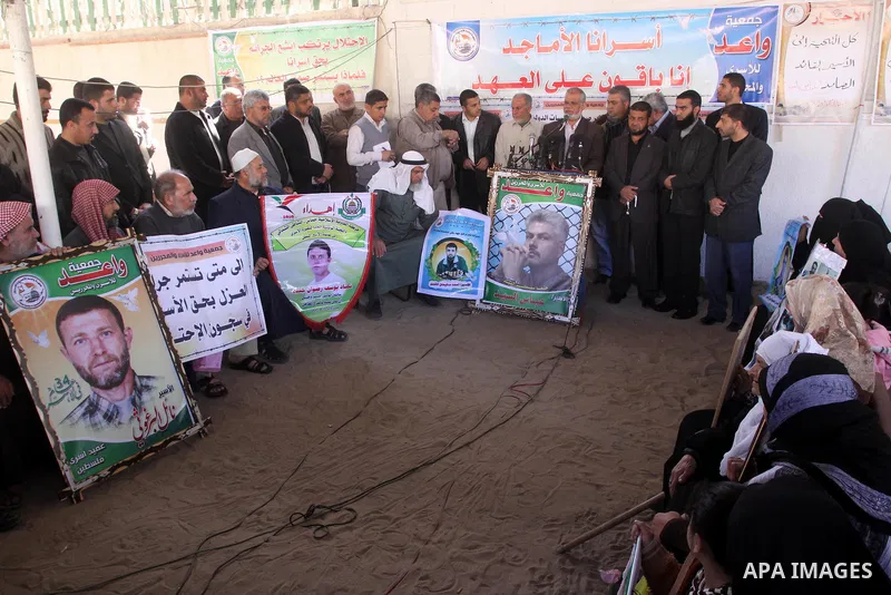 Palestinians hold pictures of jailed relatives during a protest calling for the release of Palestinian prisoners from Israeli jails in Gaza City March 17,2011 . Photo by Mohammed Asad