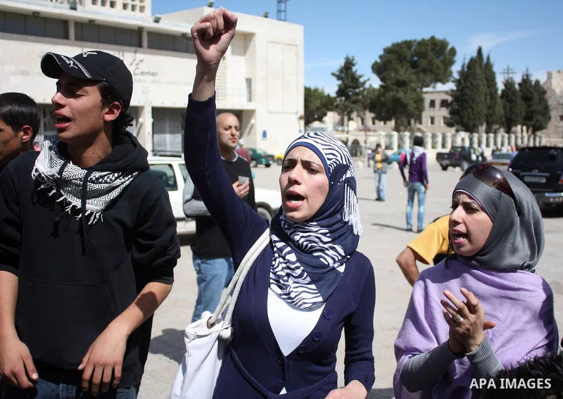 Palestinians chant slogans as they set up a tent in Manager Square in front of the Church of the Nativity in the West Bank city of Bethlehem on March 18, 2011 during a protest calling for Palestinian political unity betw...