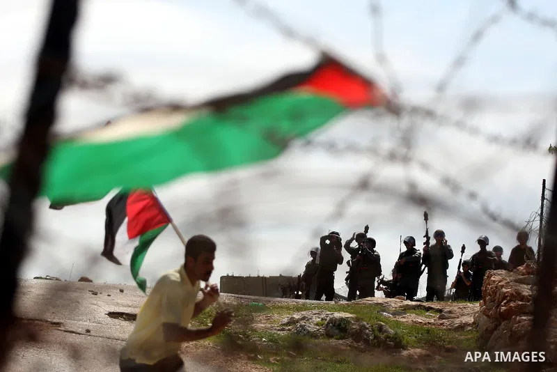 Israeli soldiers stand guard during clashes with Palestinian youths following a weekly demonstration against Israel's separation barrier in the West Bank village of Bilin on March 18, 2011. Photo by Issam Rimawi