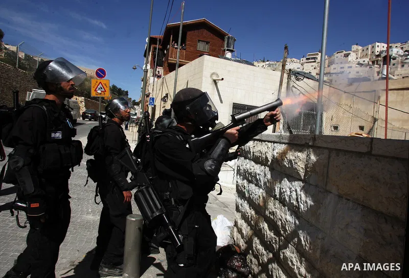 Israeli soldiers fire tear gas canisters towards Palestinian demonstrators during the clashes after Friday prayers in Jerusalem's neighbourhood of silwan on March 18, 2011. Photo by Mahfouz Abu Turk